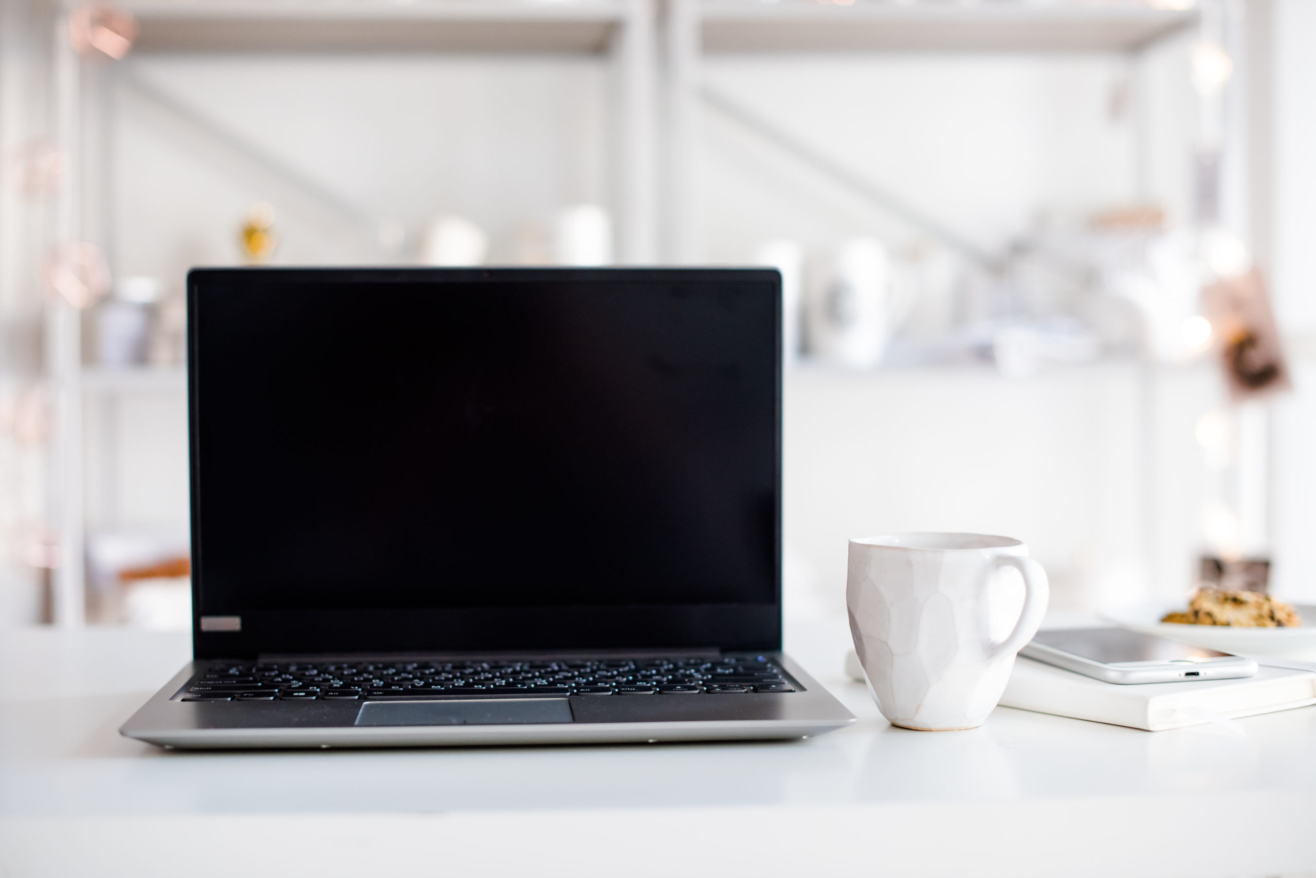 Modern white office, designer handmade cup with coffee, smartpho