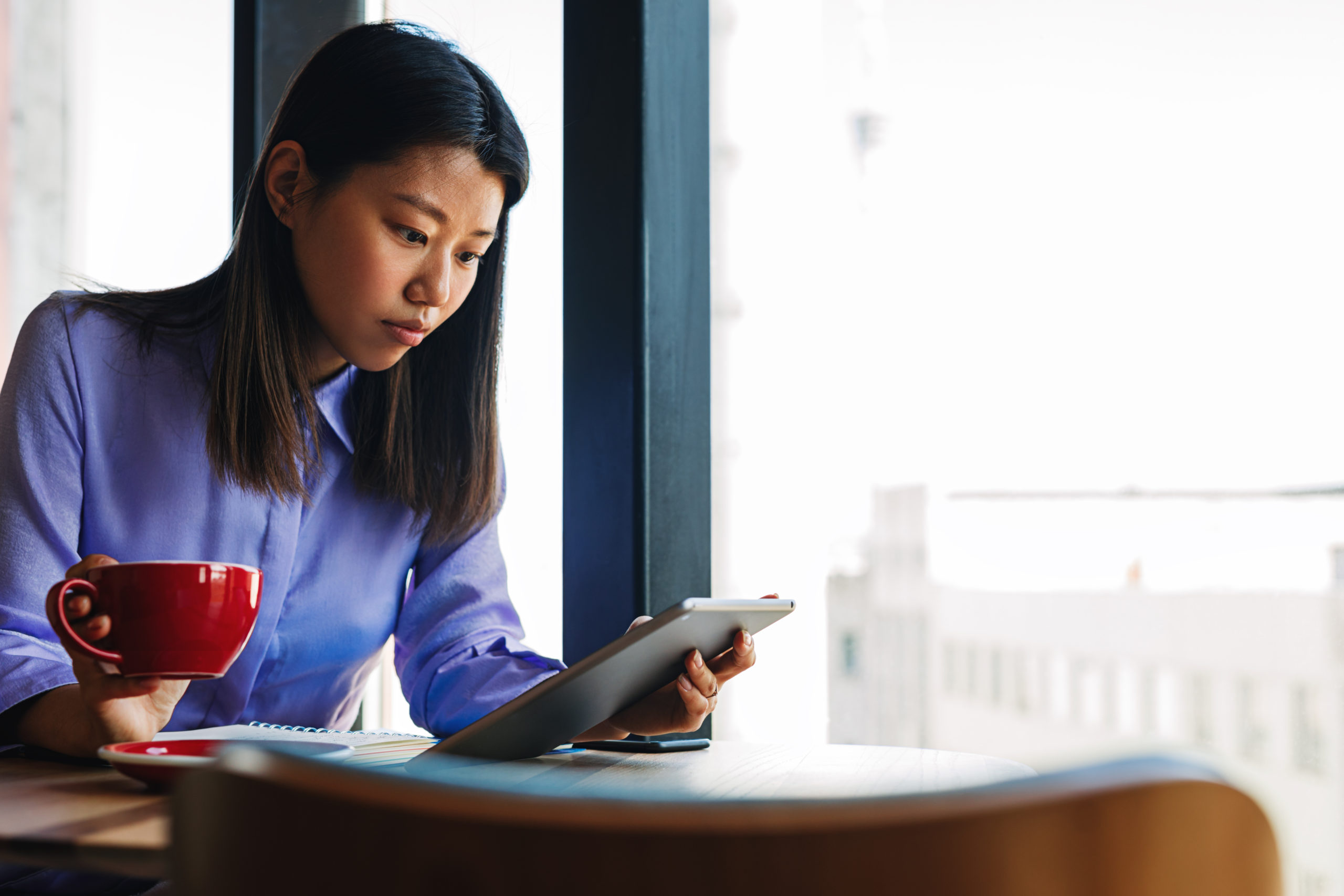 Canva - Woman Drinking Coffee and Using a Tablet